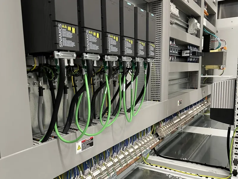 Fila di azionamenti Siemens SINAMICS con i cavi di potenza e i cavi di rete verdi